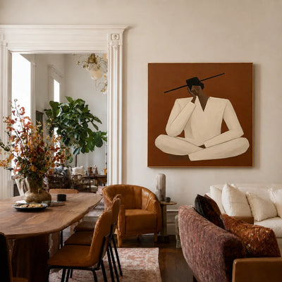 Quiet Cross-Legged Figure in Cream on Burnt Ochre Wall Art styled interior scene 3 | Olyrel